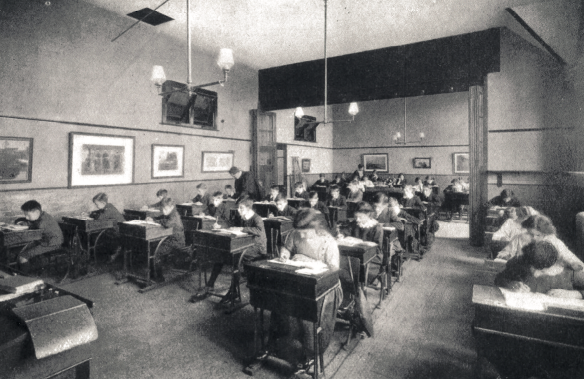 A classroom in the 1905 building, showing gas lighting and a retractable partition
